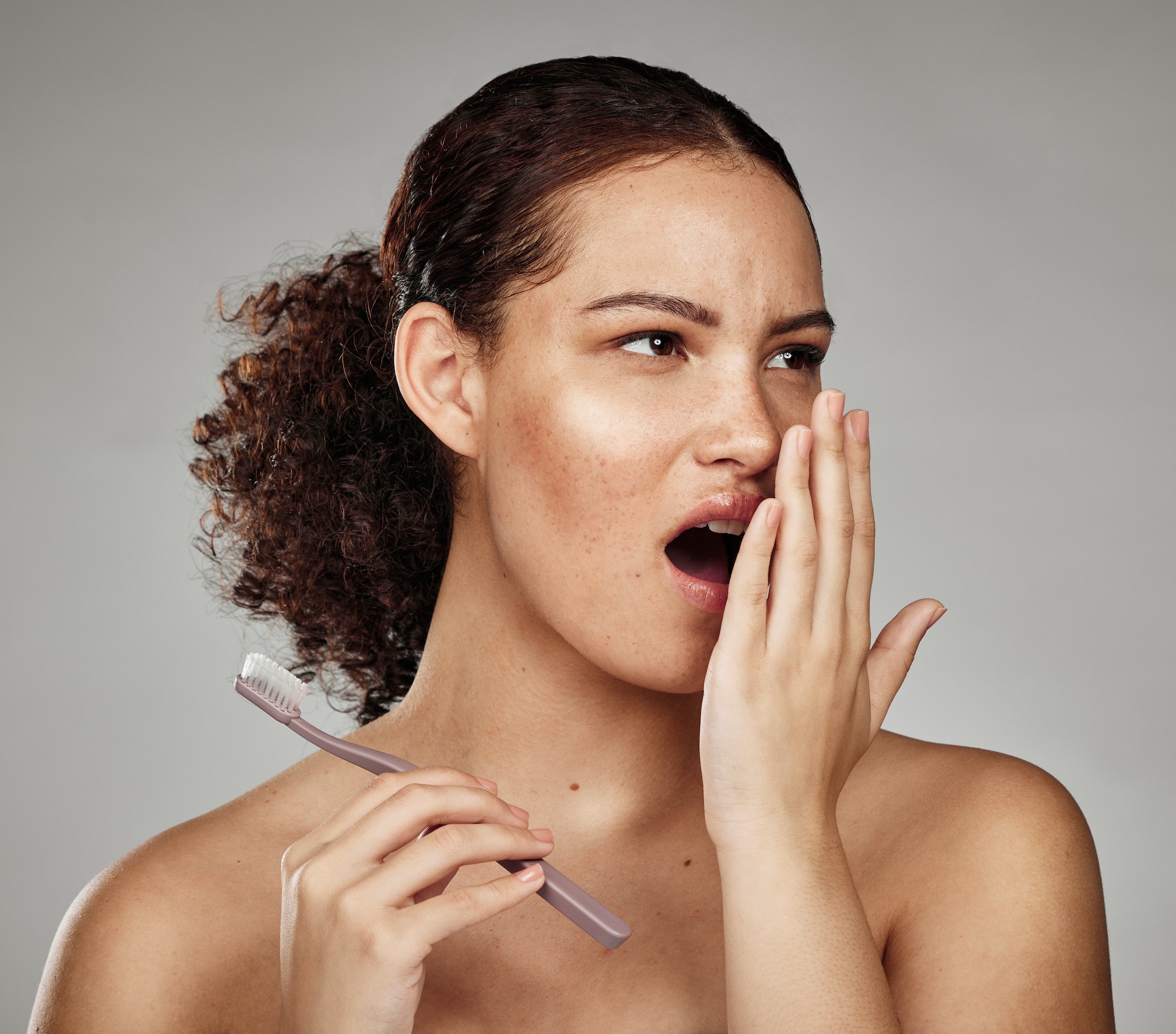 Toothbrush, woman and bad breath with dental problem while smelling odor of mouth, teeth or gums in